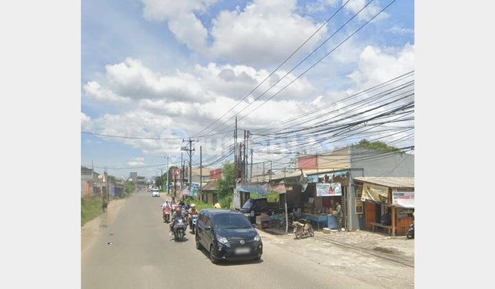 tampak depan tanah pinggir jalan raya legok
