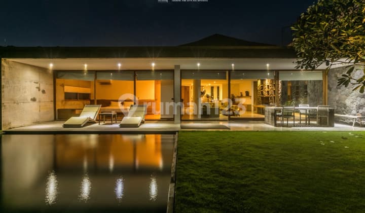 Discover this sleek three-bedroom villa in Balangan showcasing modern design, complemented by a spacious garden and inviting pool. Situated on a 915 sqm land plot with a 300 sqm building, this property is available for sale, offering a stylish and comfort