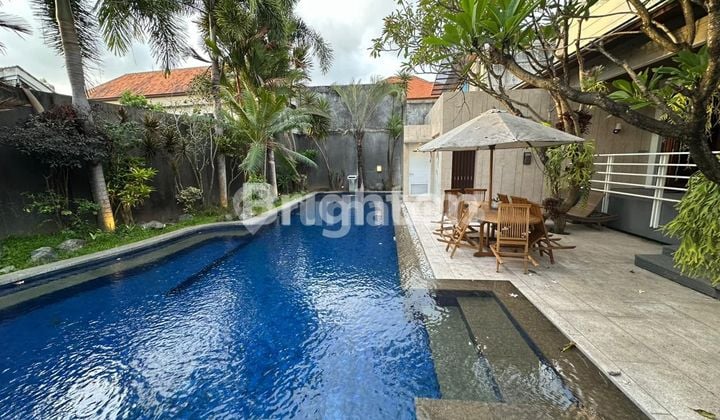 Semi-villa 3-story house with a cozy modern minimalist interior design, semi-furnished with a swimming pool, garden, and wide road access, located in West Gatsu near Kerobokan.