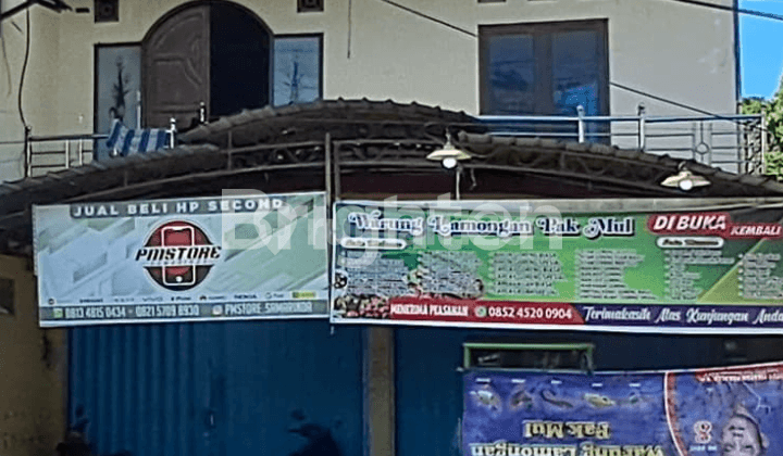 House and shop by the side of a busy road with heavy traffic. On Jalan DI Panjaitan, Samarinda.